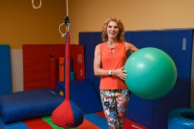 woman standing with exercise ball