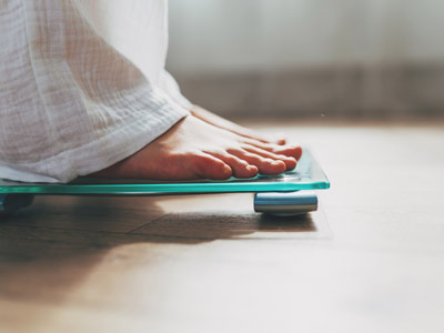 1500448393 White person standing on a scale